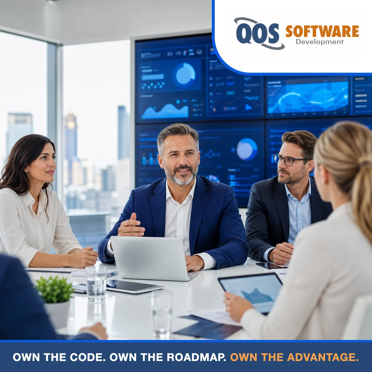 Business leaders reviewing custom software results on a wall of blue application dashboards